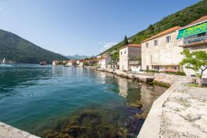 a view of a river in a town with buildings at Apartman Lepetane in Tivat