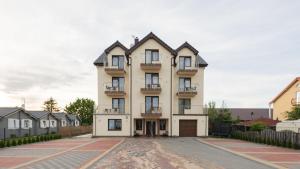 a large white building with balconies on it at Willa Basia in Ustronie Morskie