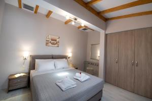 a bedroom with a bed with two towels on it at Casa Demi in Vasiliki