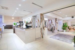 a restaurant with a counter in a room at Hotel Levante in Caorle