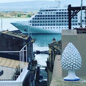 a cruise ship in the water with a sculpture in front at 4 Elements Boutique Home in Syracuse