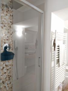 a shower with a glass door in a bathroom at Casa Rossini in Turin