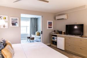 1 dormitorio con 1 cama y TV de pantalla plana en Boarding House Cape May en Cape May