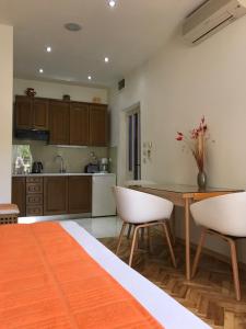 a kitchen with a wooden table and white chairs at Apartments Jani in Hvar
