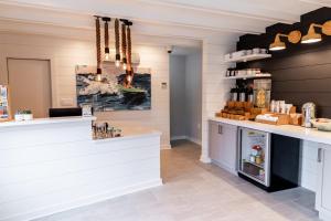 a kitchen with a counter and a refrigerator at Boarding House Cape May in Cape May