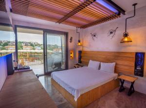 a bedroom with a large bed and a balcony at Kosa Otel Çeşme in Çeşme +93 photos