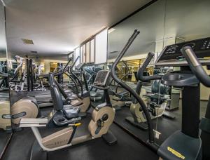 a gym with lots of treadmills and ellipticals at Aranzazu Plaza Kristal Aguascalientes in Aguascalientes