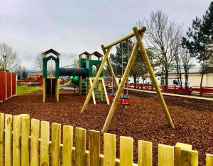 a playground with a slide in a park at Private Caravan on Ty Mawr Holiday Park, North Wales in Conwy