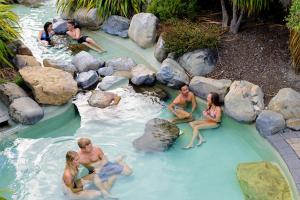 a group of people sitting in a pool of water at 8 on Oregon Boutique Lodge in Hanmer Springs