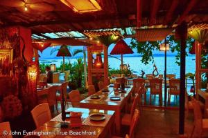 a restaurant with tables and chairs and a view of the ocean at At Seacondo-1 Bedroom-A20 in Klong Muang Beach