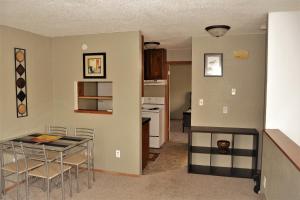 a kitchen and dining room with a table and chairs at Prairie Comfort in Grand Forks