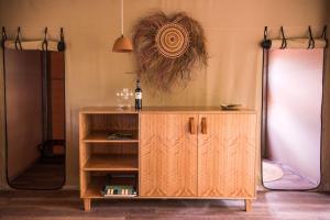 a wooden cabinet with a clock on top of it at Cooinda Lodge Kakadu in Jabiru