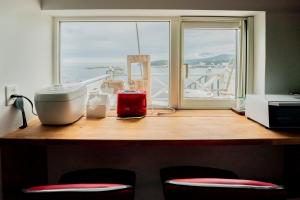 a kitchen counter with a window and some appliances at Iruka Hotel in Shari