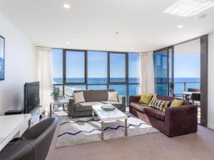 a living room with a view of the ocean at Serain Residences On Surfers in Gold Coast