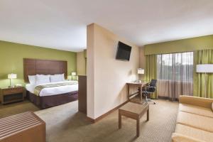 a hotel room with a bed and a desk at La Quinta Inn by Wyndham Austin North in Austin +17 photos