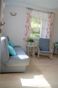 a living room with a couch and two chairs and a table at Trzy Szczęścia in Szklarska Poręba