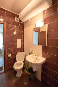 a bathroom with a toilet and a sink at Tiffany Joy Apartments in Primorsko