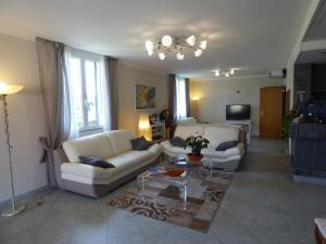 a living room with two couches and a coffee table at Hotel Turandot in Torre del Lago Puccini