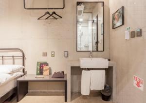 a bathroom with a sink, toilet and bathtub at Playce Camp Jeju in Seogwipo