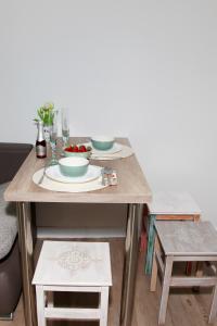 a table with plates and bowls on top of it at STUDIO LUNA in Bled