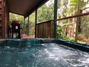 a hot tub on the back of a house at Wanderers Retreat in Nelson Bay