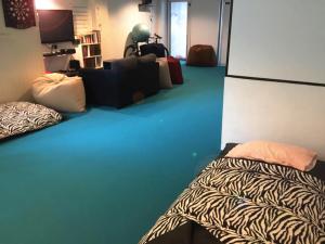 een kamer met 2 bedden en een bank. bij Edm Space in Ipoh