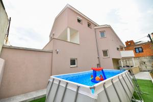 a pool in the backyard of a house at Apartment "Libra" Posedarje with pool in Posedarje