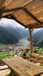 a wooden deck with a view of a lake at Kar Hotel Uzungöl in Uzungöl