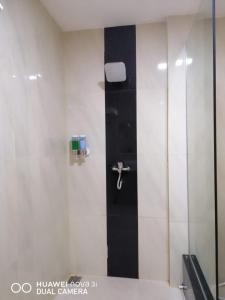 a bathroom with a shower with a faucet at Marjoly Beach Resort in Telukbakau