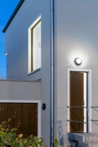 a blue and white house with a door at Cologne Country Lodge in Cologne