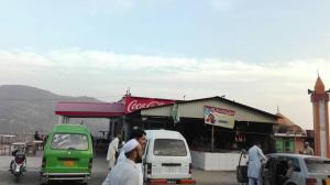 a group of cars parked in front of a store at Abbasi Hotel in Murree