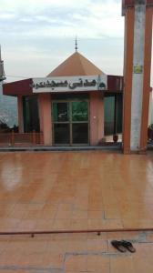 a building with a sign on the front of it at Abbasi Hotel in Murree