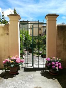 Una puerta con dos macetas de flores delante. en L'Orto di Sant'Andrea en Pisa