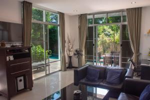 a living room with a couch and a fireplace at Comfosya BBQ Pool Villa near Jomtien Beach in Na Jomtien