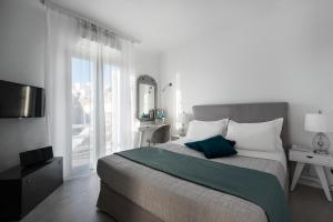 A bed or beds in a room at Riva Suites - Adults Only