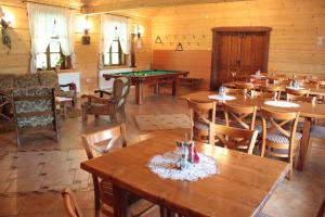 a dining room with tables and a pool table at Ostoja w Lipowcu in Jaśliska