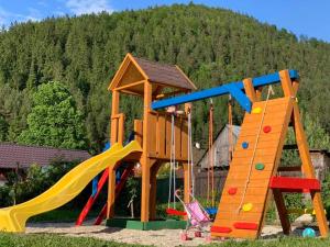 a playground with a slide and a play structure at Chata Daniela in Liptovská Osada