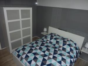 a bedroom with a bed with a checkeredkered bedspread at Vakantie woning De Loft in Dilsen-Stokkem