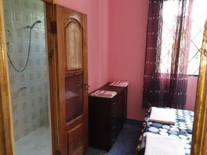 a room with a bathroom with two beds and a door at Holiday Home in Gonio in Gonio