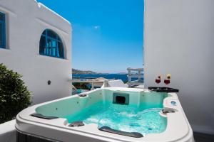a large swimming pool with a large tub at Riva Suites in Mikonos