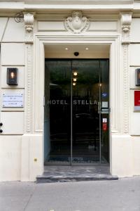 a building with a hotel sign on the side of it at Stella Etoile in Paris