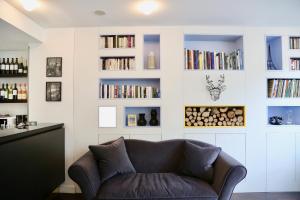 a living room with a couch and bookshelves at Stella Etoile in Paris