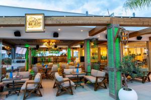 a restaurant with tables and chairs on a patio at Limanaki Beach Hotel & Suites in Ayia Napa