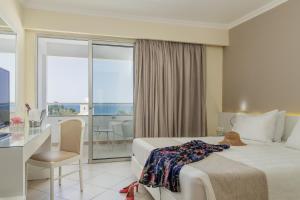 A bed or beds in a room at Lindos Village Resort & Spa - Adults Only Még 37 kép