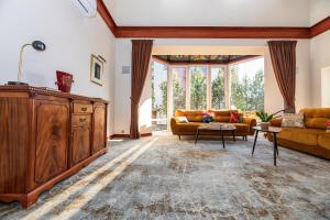 a living room with two couches and a large window at Vila Ieva in Palanga