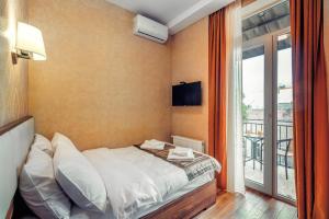 Postel nebo postele na pokoji v ubytování Ornament Hotel