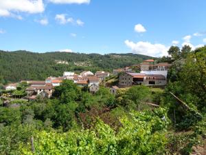 a village on a hill with trees and buildings at Casa Carolina in Vila Seca