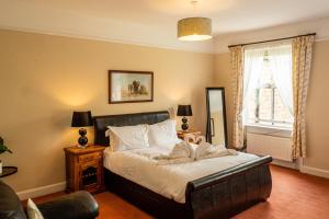a bedroom with a large bed and a window at Prince Rupert House at The Red House Estate in York +23 photos
