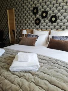 - une chambre avec 2 lits et des serviettes blanches dans l'établissement Chambre d'Hôte Noalhat - Zenith d'Auvergne, à La Roche-Blanche