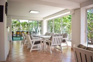 a dining room with a white table and chairs at Hotel Ville De Paris in Riccione